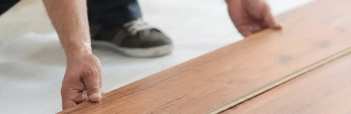 A professional installing laminate flooring in San Francisco, CA